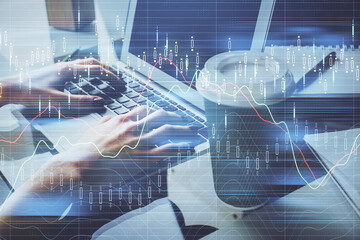 Double exposure of woman hands typing on computer and forex chart hologram drawing. Stock market invest concept.