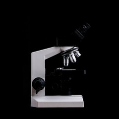 Closeup of Scientific microscope isolated on black, data analysis in the laboratory