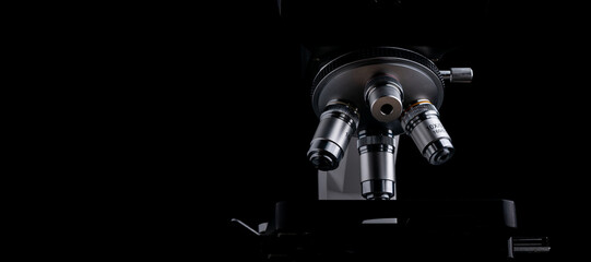 Closeup of Scientific microscope isolated on black, data analysis in the laboratory