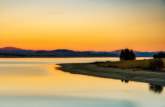 Stunning calm waters of Lake Pukaki at sunset on the way back from walking the Hooker Valley track in Aoraki Mount Cook  National Park - Powered by Adobe