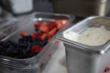 Ricotta Chees and Berries in Food Prep Containers at Restaurant Ready for Breakfast Service