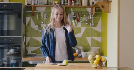 Woman cut her finger with knife while chopping fruit