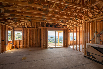 Fototapeta na wymiar A new luxury home being built on a hilltop with views visible through the framed windows in Spokane, Washington