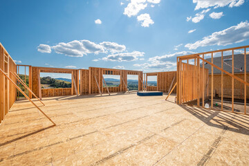 A new construction home being framed on a hillside with a view overlooking Spokane Valley, Washington