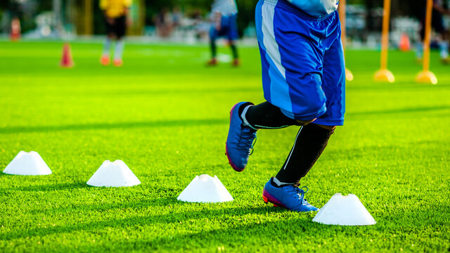 Low Section Of Person Running Over Hurdles On Playing Field