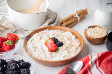 oatmeal with berries in wood bowl