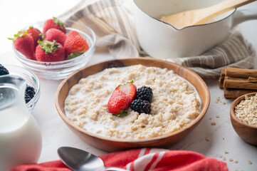 oatmeal with berries in wood bowl