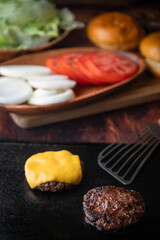 cooking burger patty on iron pan