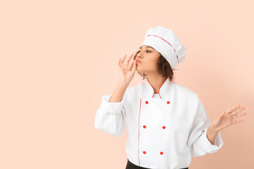 Female African-American chef on color background