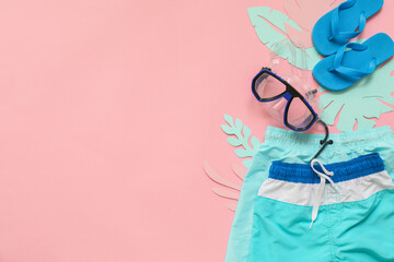 Composition with beach accessories on color background