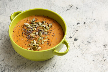 Pot of tasty lentils soup on light background