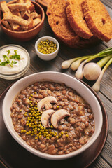 Bowl of tasty lentils soup on table