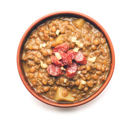Bowl of tasty lentils soup on white background