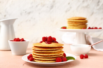 Sweet pancakes with berries on table