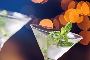 Glasses of fresh martini on dark background, closeup