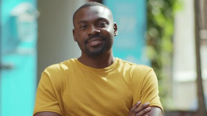 Smiling african amerian man look at camera stand in street city cheerful black portrait sunny urban happy handsome face confident slow motion