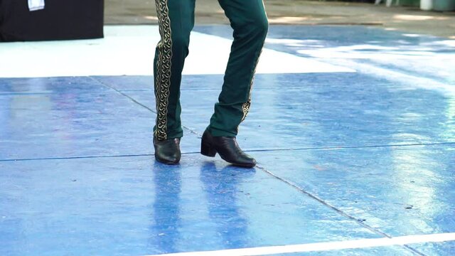 Young Man In Mariachi Pants Doing A Latin Dance With Shoes