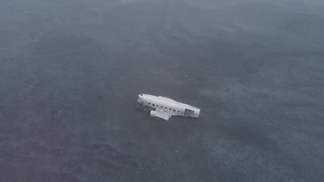 Iceland's downed DC-8 S&oacute;lheimasandur plane from an aerial view 4K at black sand beach
