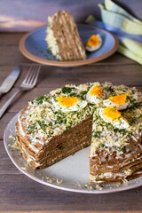Layered liver cake with cheese, mayonnaise and dill