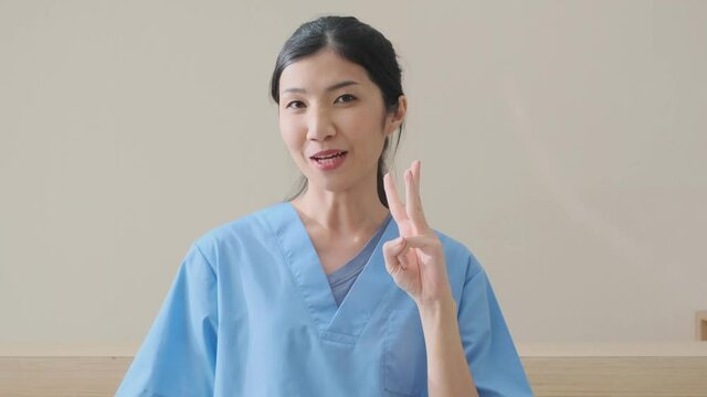 portrait of smart asian female doctor explain and suggesting a way to takecare yourself with happiness smiling cheerful Caring for patients at the hospital