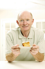 Senior man with a slice of cake