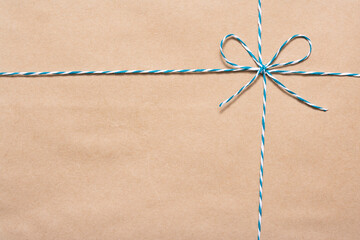 string or twine tied in a bow isolated on brown background