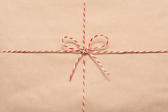 String Or Twine Tied In A Bow Isolated On Brown Background