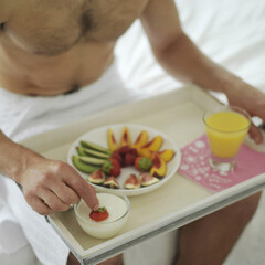Obraz na płótnie Canvas Man having breakfast in bed
