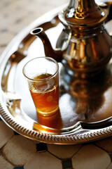 Teapot and glass on tray
