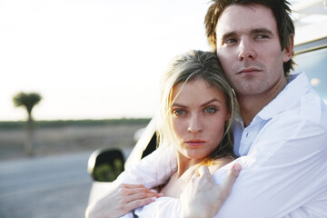 Man hugging his girlfriend from behind