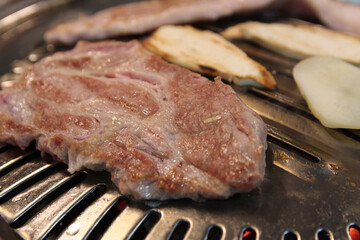 Korean grilled pork BBQ (Samgyeopsal-gui) with charcoal at Korean restaurant, Busan, South Korea