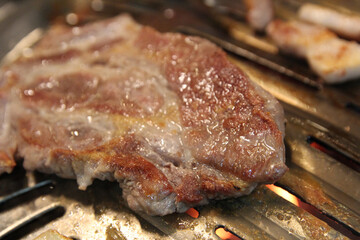 Korean grilled pork BBQ (Samgyeopsal-gui) with charcoal at Korean restaurant, Busan, South Korea