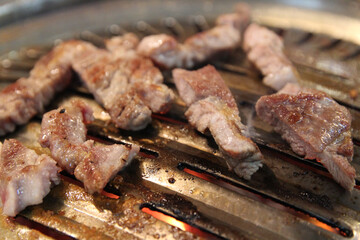 Korean grilled pork BBQ (Samgyeopsal-gui) with charcoal at Korean restaurant, Busan, South Korea