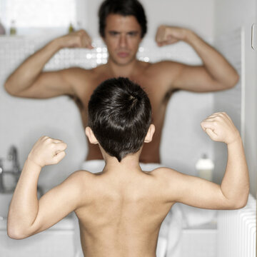 Father and son showing off their muscular arms
