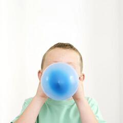 Boy blowing balloon