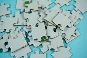 random white jigsaw puzzle incomplete concept on blue background