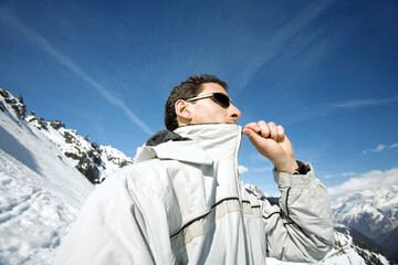 Man zipping up his jacket © ImageHit