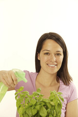 Woman spraying a potted plant