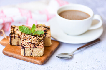 cake chocolate slice on wooden board background with mint leaf and coffee cup for breakfast - Coffee cake delicious dessert served on the table