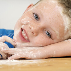 Boy with flour on his face