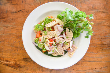 Spicy Vietnamese Sausage with salted egg with egg yolk and vegetable - Vietnamese pork sausage salad on a plate
