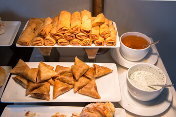 Chinese shrimp spring rolls on platter in hotel reception room