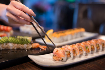 girl used chopsticks in salmon rolls © lmanju