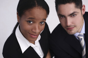Businessman and businesswoman smiling while looking up