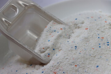 washing soap powder with scoop