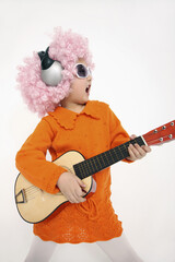 Girl with sunglasses and headphones playing with guitar