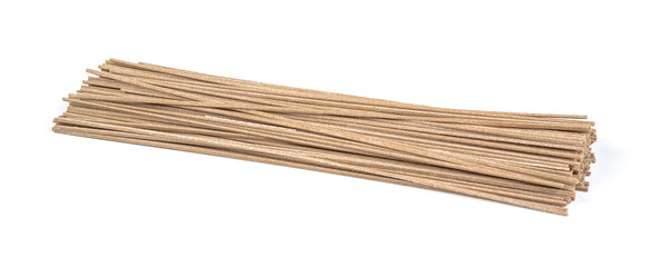 Dried raw japanese soba noodle sticks isolated on a white background.