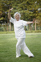 Senior woman practising tai chi in the park