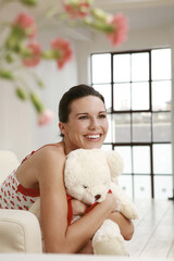 Woman hugging a soft toy