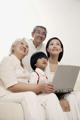 Fototapeta premium Boy and woman together with senior couple smiling while looking up